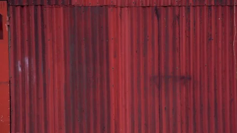 Medium shot of man pushing touring bicycle and leaning against red wall. Stock Footage 127219513