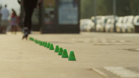 Medium shot of man on rollerblades weaving through cones / Nice, France Stock Footage 38861705