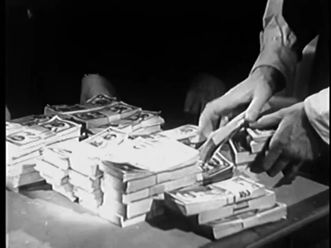 Medium shot of man stacking bundles of money on table Stock Footage 260256265