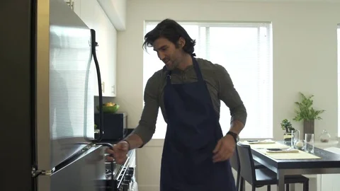 Medium shot of a man taking out ingredients from a refrigerator Stock-Footage 76235027