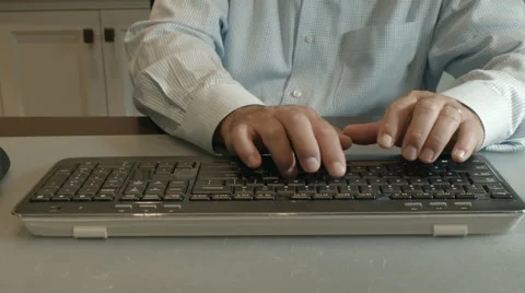 Medium shot of man Typing on a Computer Keyboard 動画素材 68197388