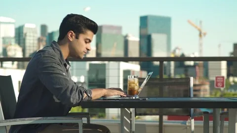 Medium shot of man using laptop outside 動画素材 76540512