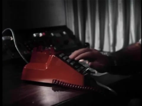 Medium shot of man using push button phone Stock Footage 260254641