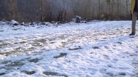 Medium shot of a man walking over fresh snow during winter, Zagreb, Croatia. Video stock 146773815