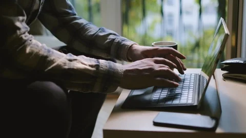 Medium shot of man working on laptop at home office Stock Footage 95392036
