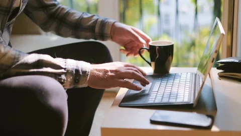 Medium shot of man working on laptop at home office 스톡 동영상 95392085
