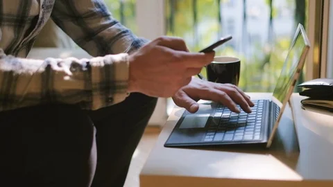 Medium shot of man working on laptop at home office Stock Footage 95392129