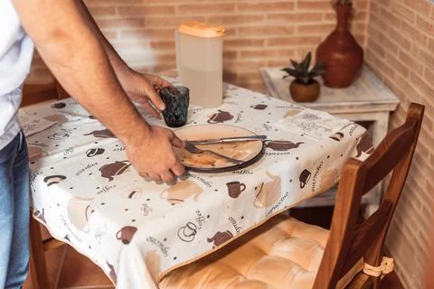 Medium shot of a man's hands picking up the dirty plate Stock Photos
