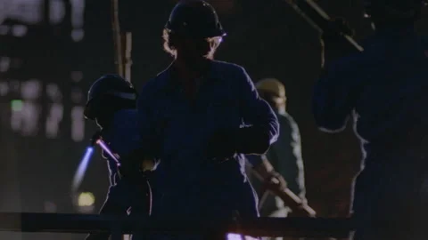 Medium shot of men working with metal Stock Footage 312273087