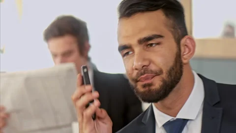 Medium shot of middle eastern business man on mobile phone and doing a deal in c Stock-Footage 199633807