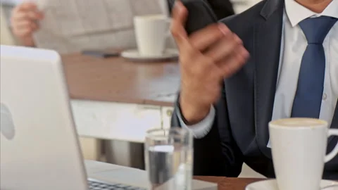 Medium shot of middle eastern business man on mobile phone and doing a deal in c Stock Footage 199633841