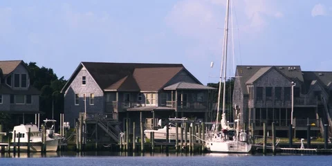 Medium shot of mooring post and Ocracoke village in background Stock Footage 103489432