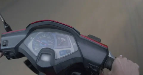 A medium shot of a moped speedometer
cruising on the open road. Stock Footage 138848019