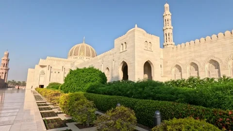 Medium shot of mosque with trimmed bushes and trees in Oman Video stock 339888915