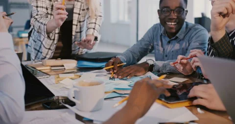 Medium shot of multiethnic creative marketing team working on brainstorming Stock Footage 106155994