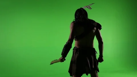 Medium shot of native with weapon from behind in front of green screen Stock Footage 81563010