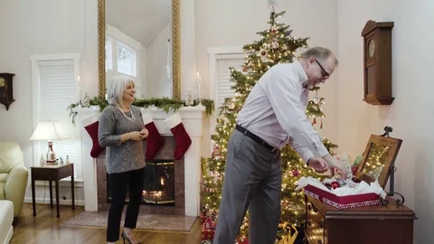 Medium shot of an old couple decorating a Christmas tree 動画素材 73107110