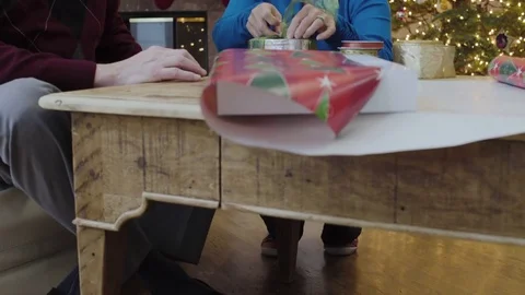 Medium shot of an old couple wrapping a gift for Christmas 動画素材 73110553