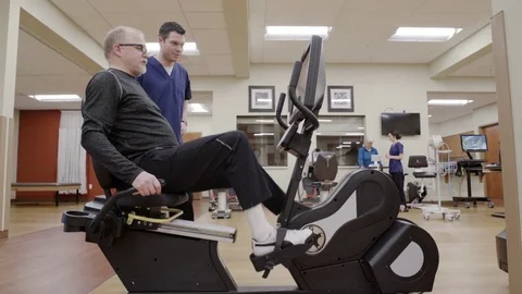 Medium shot of an old man using a rehabilitation bicycle Stock Footage 71826769