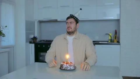 Medium Shot One Crying Man Hiding Face Near Lit Birthday Cake Domestic Video stock 333256124