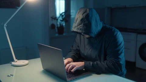 Medium Shot One Hacker In Hoodie Thinking And Typing On Laptop Stock Footage 333270695
