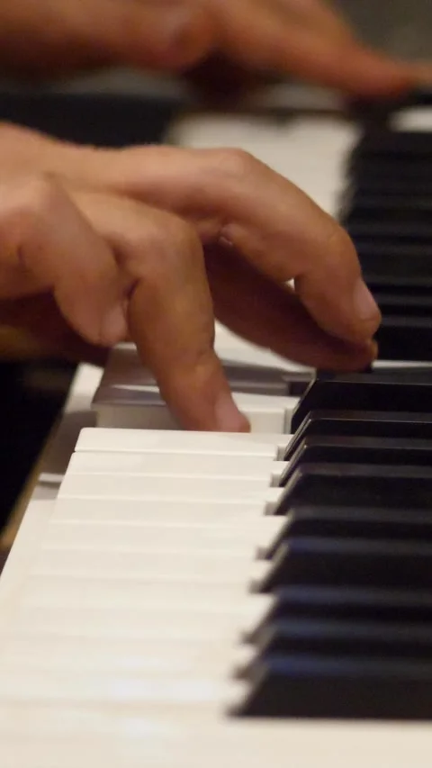 Medium shot of one hand playing electronic keyboard Stock Footage 230665255