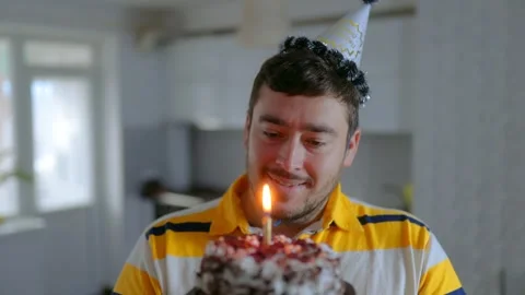 Medium Shot One Happy Man Smiling And Blowing Birthday Candle Stock Footage 334042720