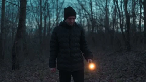 Medium Shot One Man With Flashlight Looking Around Dark Forest lifestyle Видео 334002039