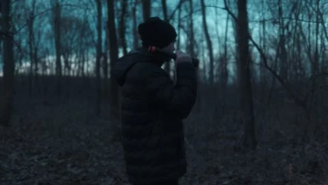 Medium Shot One Man Pointing Flashlight Beam At Camera Lens lifestyle Stock Footage 334002195