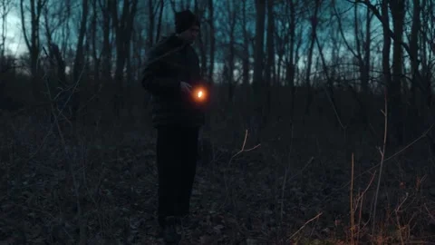 Medium Shot One Man Scanning Dark Forest With Flashlight lifestyle Stock Footage 334002198