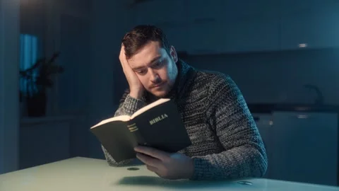 Medium Shot One Man Sitting At Table Reading Holy Bible At Night Stock Footage 333270777