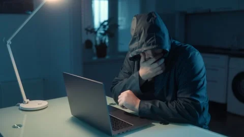 Medium Shot One Stressed Hacker In Hoodie Covering Face Near Laptop Stock Footage 333270669