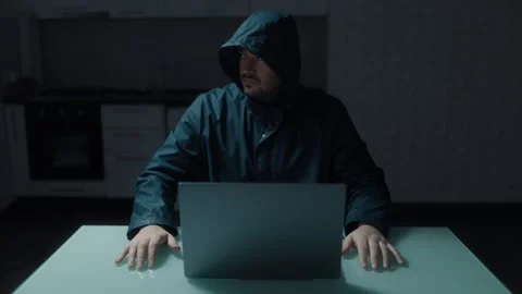 Medium Shot One Suspicious Hacker In Hoodie Looking Around Laptop Stock Footage 333270639