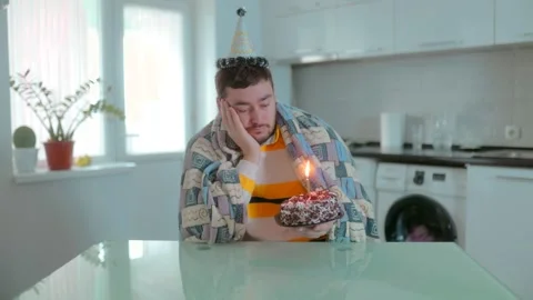 Medium Shot One Tired Man In Blanket Resting Near Birthday Cake Vídeo Stock 334042792