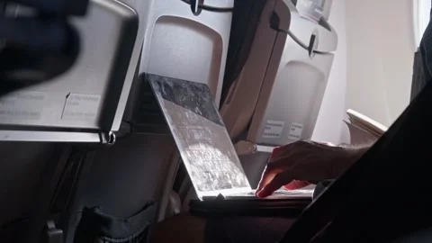 Medium shot of passenger using laptop on airplane interior, Istanbul Stock Footage 347874567