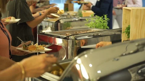 Medium shot of people dishing up various delicious foods at a function. 스톡 동영상 95937999