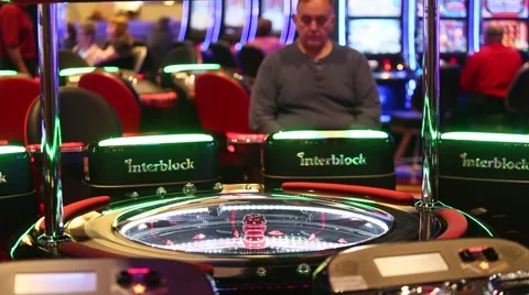 MEDIUM SHOT OF PEOPLE PLAYING ROULETTE MACHINES AT CASINO Stock-Footage 59923308