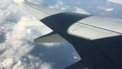 Medium shot of plane wing with clounds in the background Stock Footage 160806902
