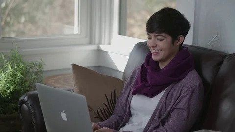 Medium shot of pleasant young lady working on her laptop Stock Footage 70809780
