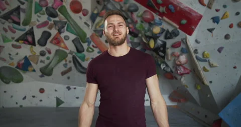 Medium shot portrait of a young bearded smiling climber crossing arms Stock Footage 131351354