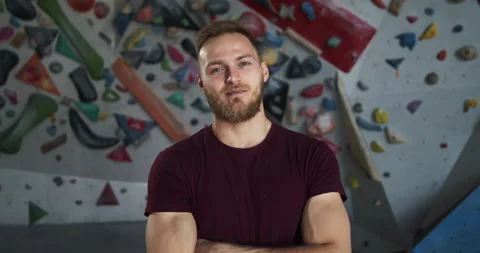 Medium shot portrait of a young bearded smiling climber with crossed arms Stock Footage 131351469