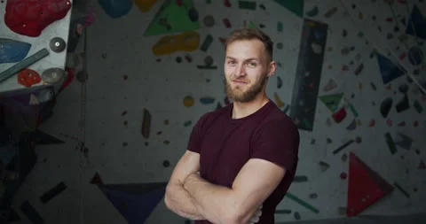 Medium shot portrait of a young bearded smiling climber with crossed arms Stock Footage 131362805