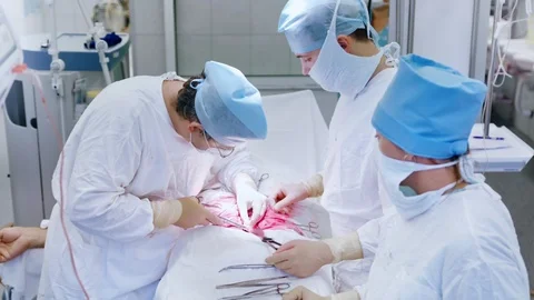 Medium shot professional surgeon making stitching using thread during performing Video stock 99656000