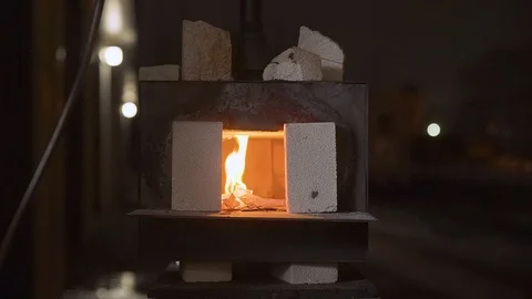 Medium shot of a propane forge starting up outside in the darkness of the Stock Footage 114150223
