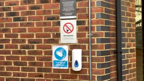 Medium shot of Public Hand Sanitiser, attached to wall. Stock Footage 153109646