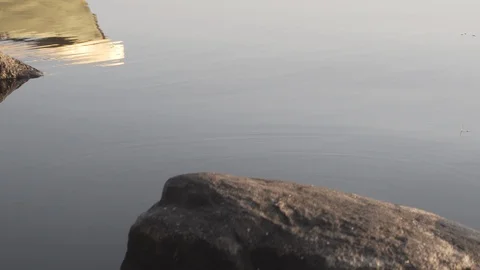 Medium shot of the reflection of a rowboat on a lake in Finland Stock Footage 113961914