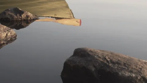 Medium shot of the reflection of a rowboat on a lake in Finland Stock Footage 113962303