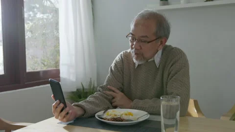 Medium shot : Retired gray haired grandpa asian man sit alone using mobile 스톡 동영상 140778955