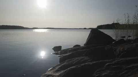 Medium shot of rocks on a lake against beautiful lake view in Finland Stock Footage 113961741