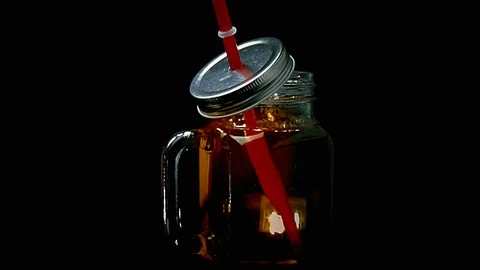 MEDIUM SHOT ROTATING JAR OF ICE TEA 動画素材 93972477